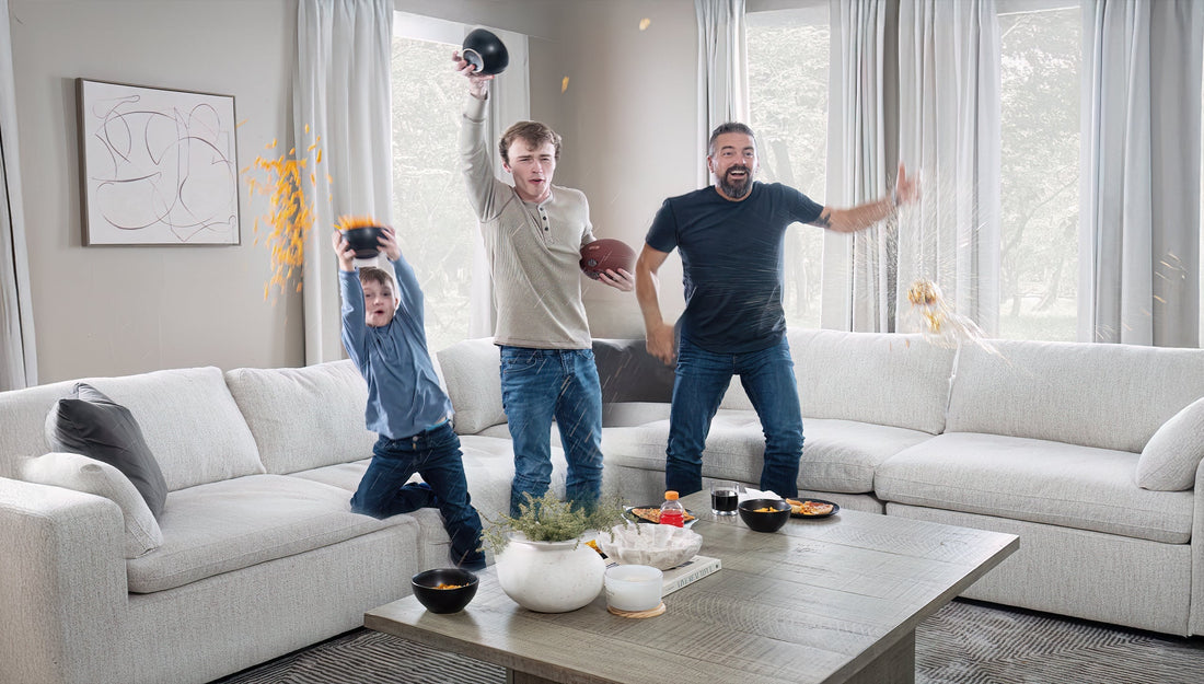 Friends celebrating a football game in their living room