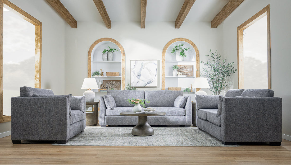 A living room with three gray sofas