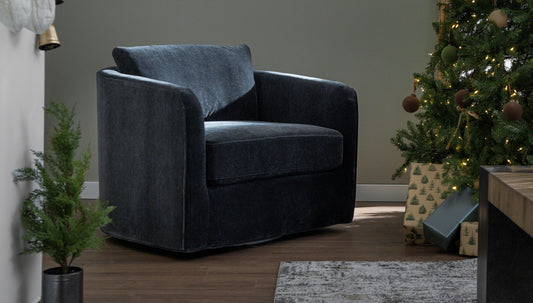 An accent chair next to a Christmas tree