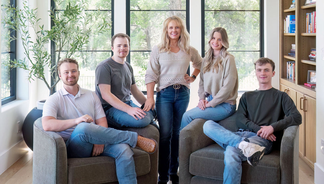 A family of five sitting in a living room.